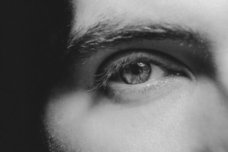 a black and white photo of a man's eye