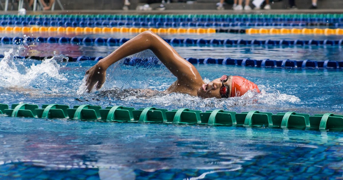 Swimmer in a pool lane, illustrating the return to swimming after LASIK